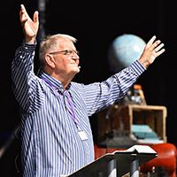 Terry Virgo worshipping on a conference platform